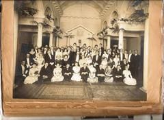 A group of people sitting in front of a building.