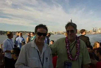 Two men standing next to each other on a boat.