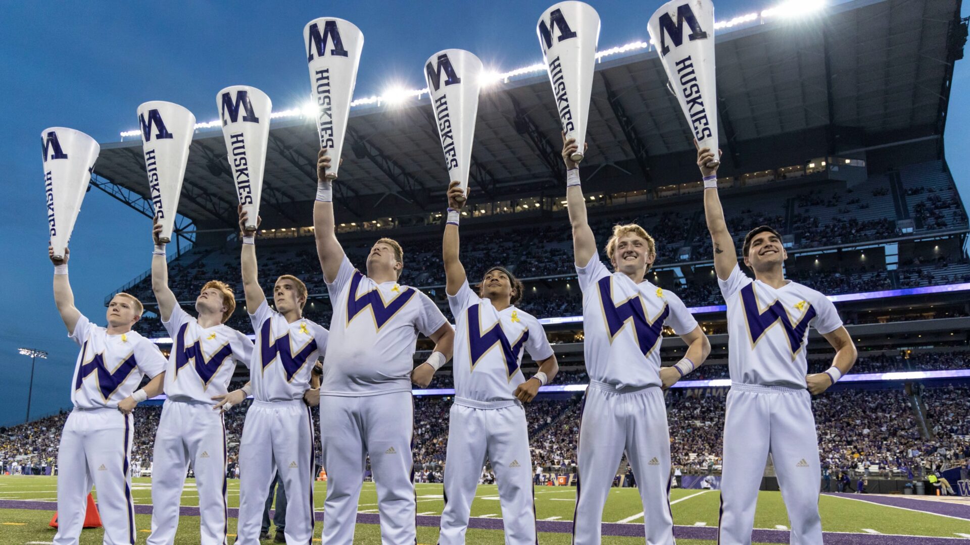 A group of baseball players holding up their bats.