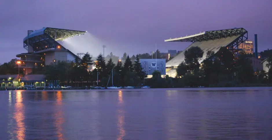 A view of the water and stadium lights at night.